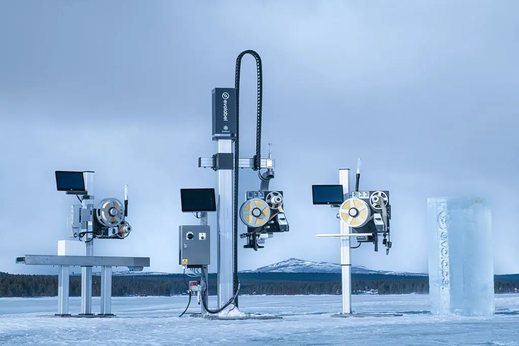 Industrial pallet labeling equipment set up on a snow-covered icy field